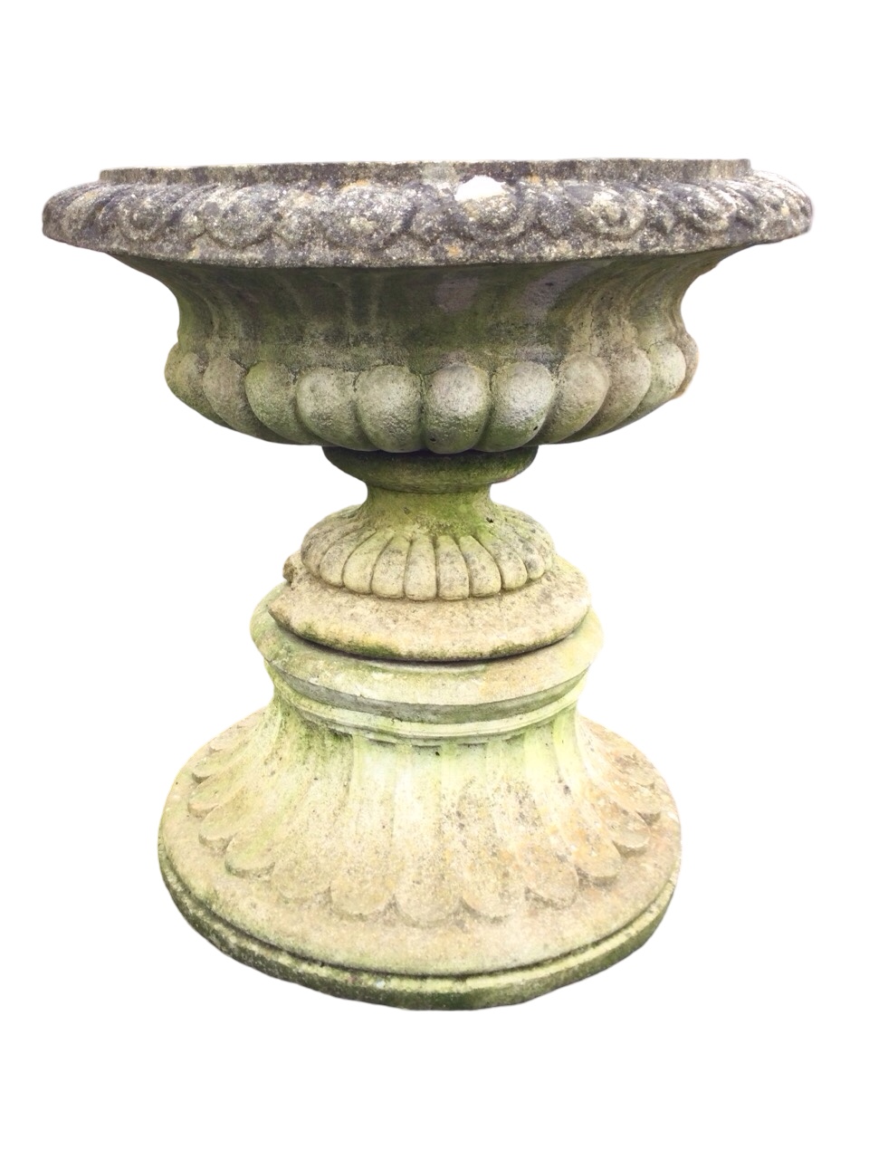 A composition stone urn with egg & dart moulded overhanging rim above a lobbed body and fluted