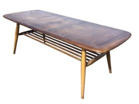 An Ercol elm & beech coffee table with rounded rectangular top raised on turned legs joined by a