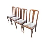 A set of four Edwardian hardwood Queen Anne style dining chairs, the arched backs with shaped