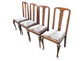 A set of four Edwardian hardwood Queen Anne style dining chairs, the arched backs with shaped