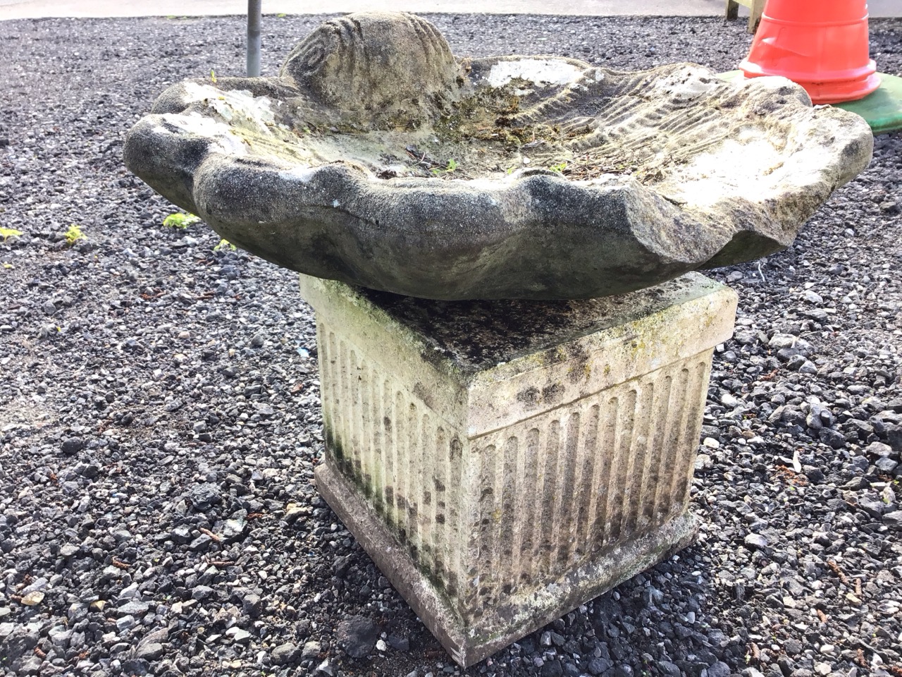 A composition stone shell cast birdbath mounted on an associated square fluted column support. ( - Image 3 of 3