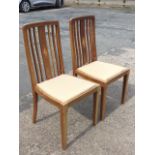 A pair of Edwardian mahogany chairs with rectangular boxwood strung slatted backs and floral
