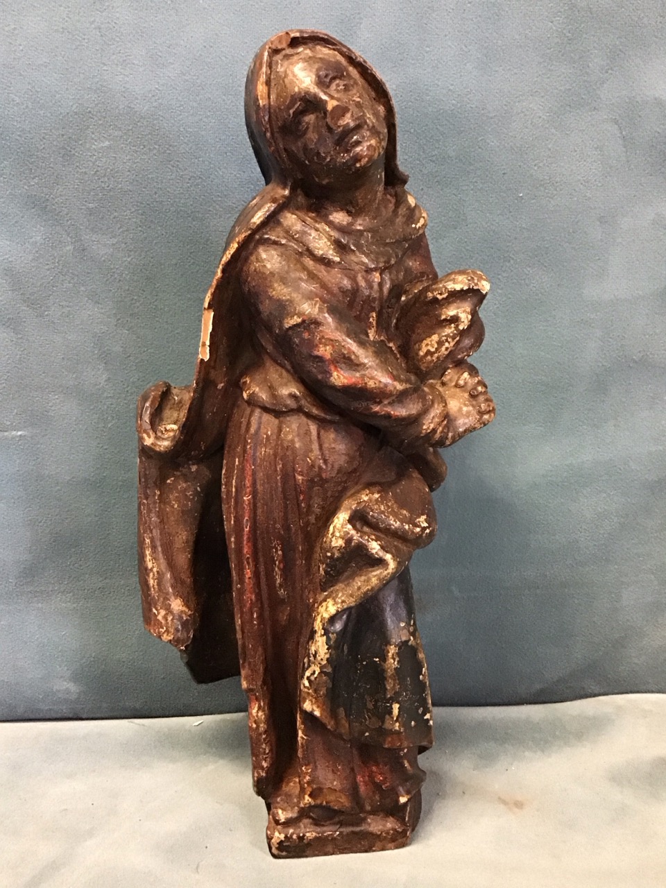 A C16th German carved and polychrome painted figure of Mary mater dolorosa, depicted with clasped