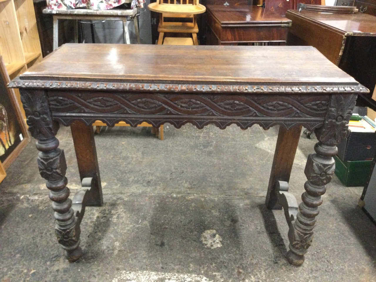 A Victorian oak jacobean style console table with rectangular leaf carved top above a waved ribbon - Image 2 of 3