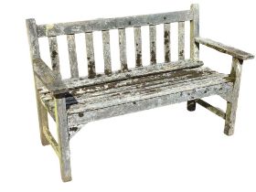 A 4ft Lister Burmese teak garden bench of slatted construction with platform arms, raised on