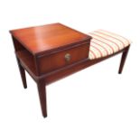 A mahogany telephone table with square top above an open compartment with faux drawer front,