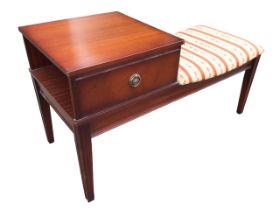 A mahogany telephone table with square top above an open compartment with faux drawer front,