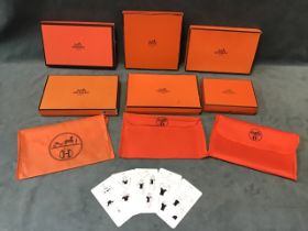A collection of six Hermès boxes of various sizes; three orange canvas pouches with the Hermès logo;