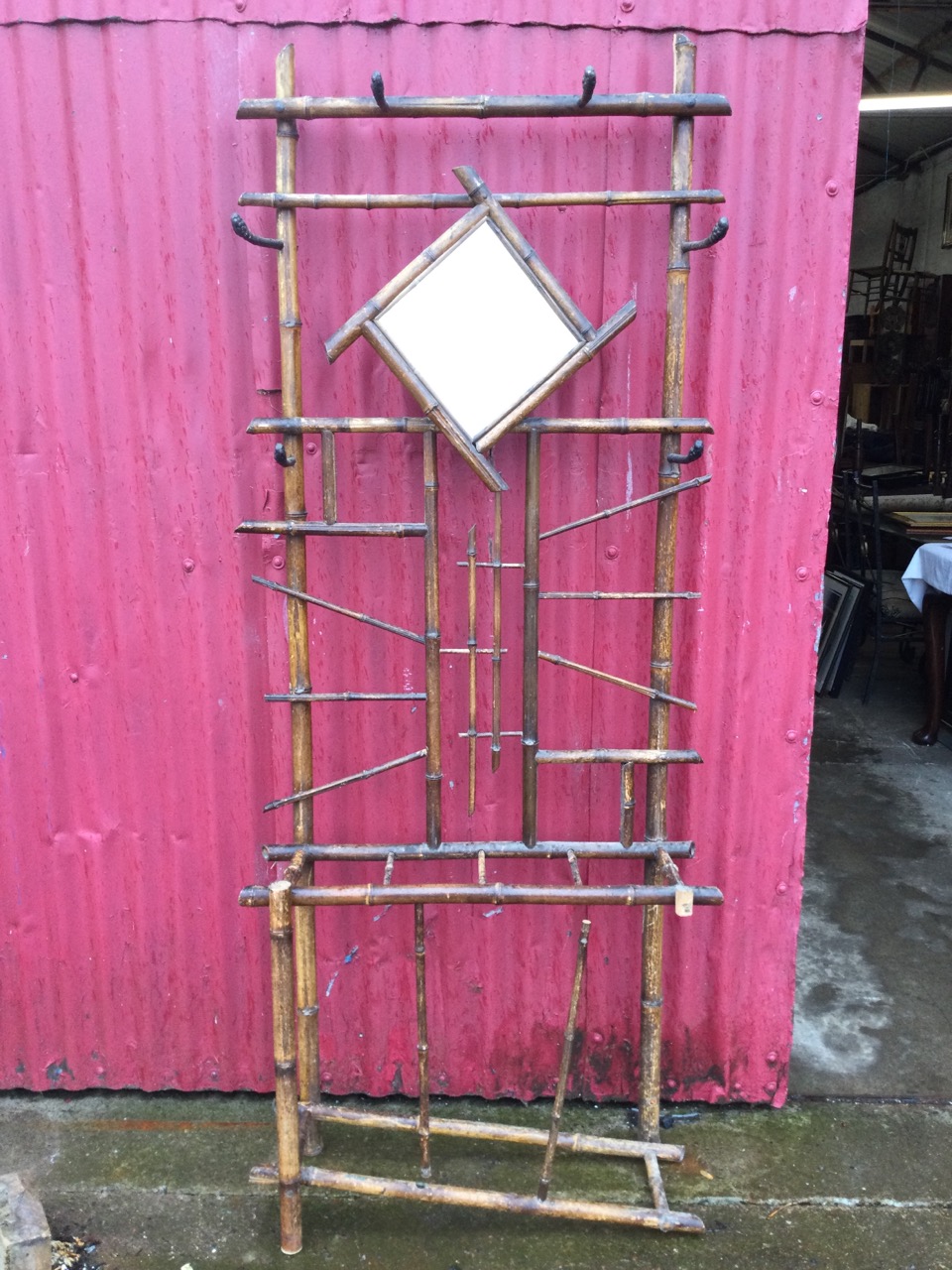 An Edwardian bamboo hallstand, the back mounted with six iron pegs and framed mirror, the base - Image 2 of 3