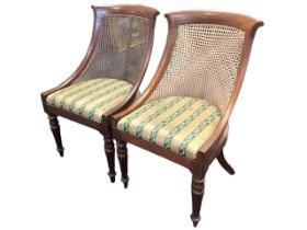 A pair of regency mahogany bergère Gillows style chairs with curved caned backs above upholstered