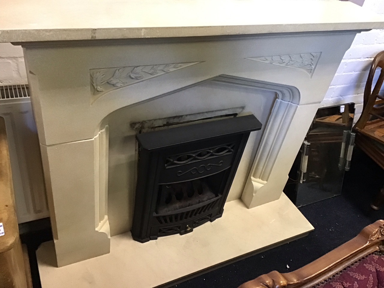 A faux limestone chimneypiece with rectangular mantlelshelf above a gothic shaped moulded aperture - Image 3 of 3