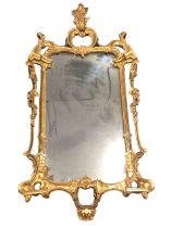 A Chippendale style rococo giltwood wall mirror, the acanthus and foliate scrolled crest above a