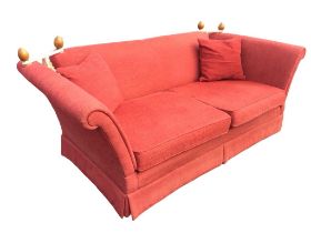 A Laura Ashley knole house sofa with drop arms and turned finials to roped back, having loose