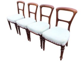 A set of four Victorian mahogany dining chairs with arched backs and scrolled rails above bowfronted
