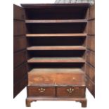 A Georgian walnut press cupboard with crossbanded doors enclosing a fitted interior with oak tray