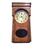 A 30s deco oak cased wallclock with brass dial and movement striking on gongs, the glazed door