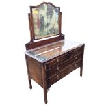 A stained mahogany dressing table with carved pierced spandrels, the scalloped framed bevelled