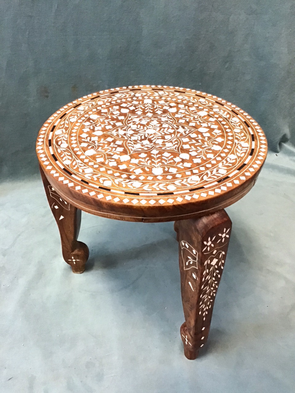 An Indian hardwood low table with circular top profusely inlaid in bone with floral motifs raised on - Image 3 of 3