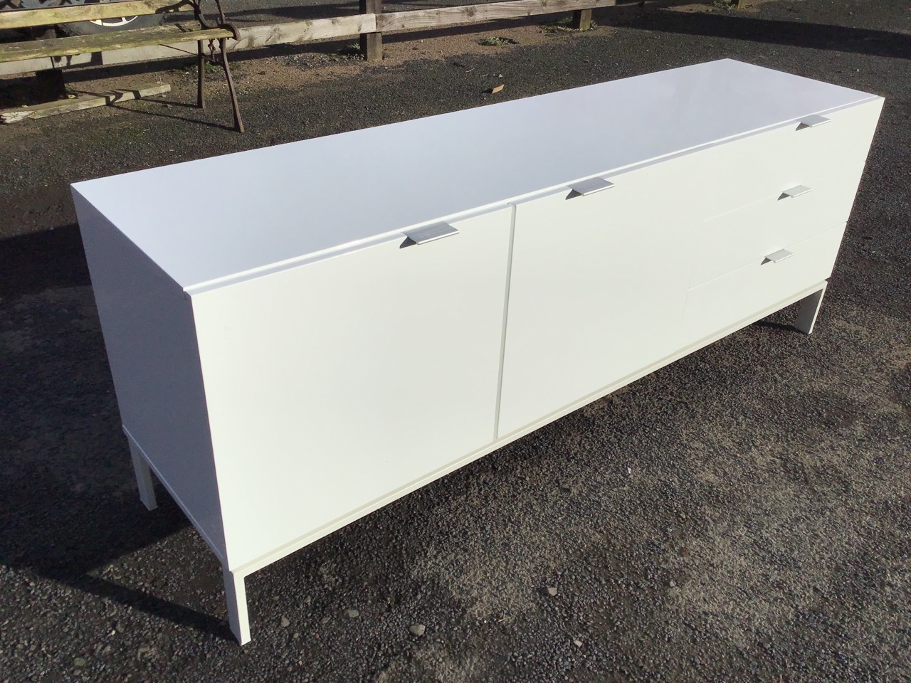 A contemporary white lacquered sideboard, the rectangular top above two cupboards and three drawers, - Image 3 of 3