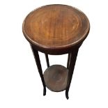 An Edwardian mahogany jardiniere stand with circular boxwood strung top above a plain apron,