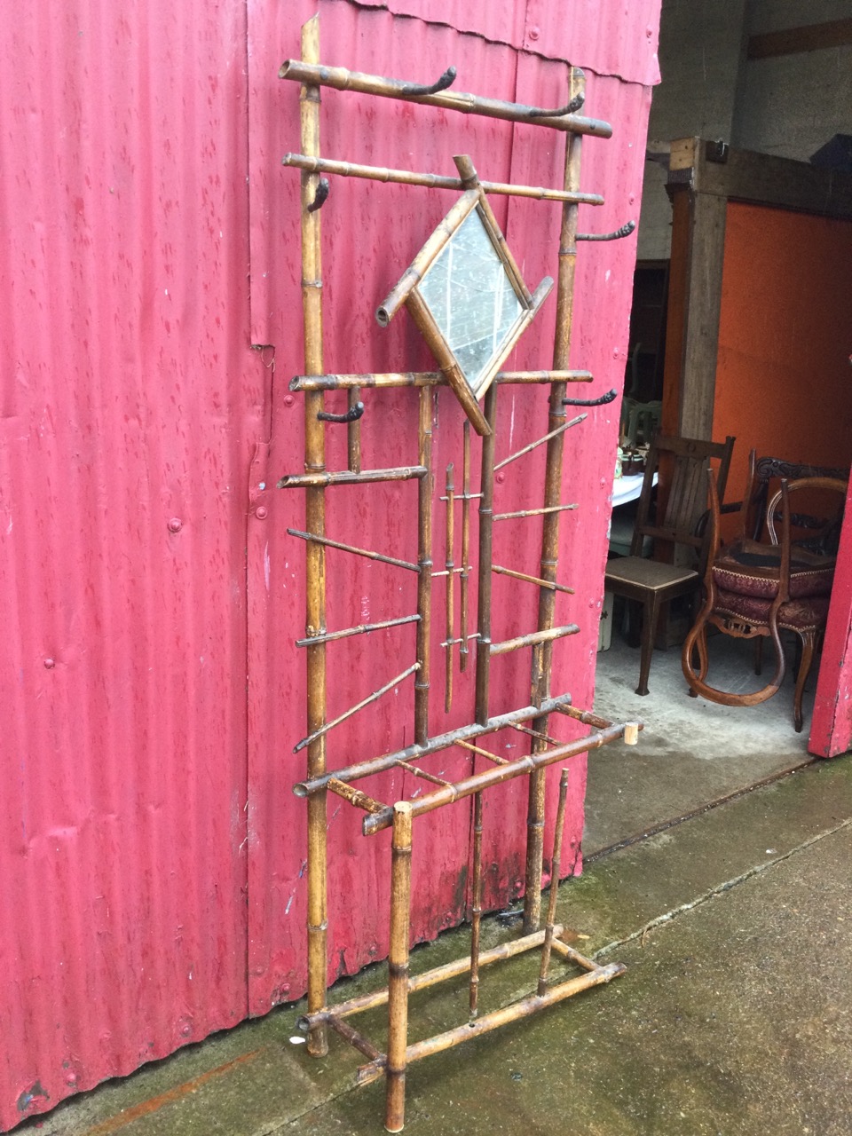 An Edwardian bamboo hallstand, the back mounted with six iron pegs and framed mirror, the base - Image 3 of 3