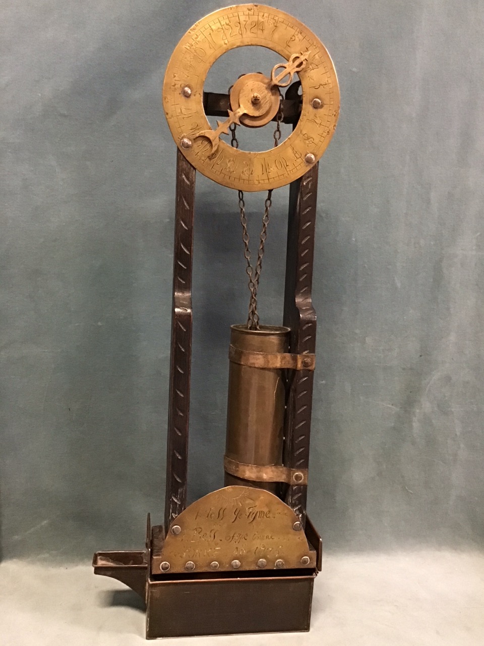 An Edwardian oak, brass & copper twenty-four hour water clock, the brass chapter ring with arabic