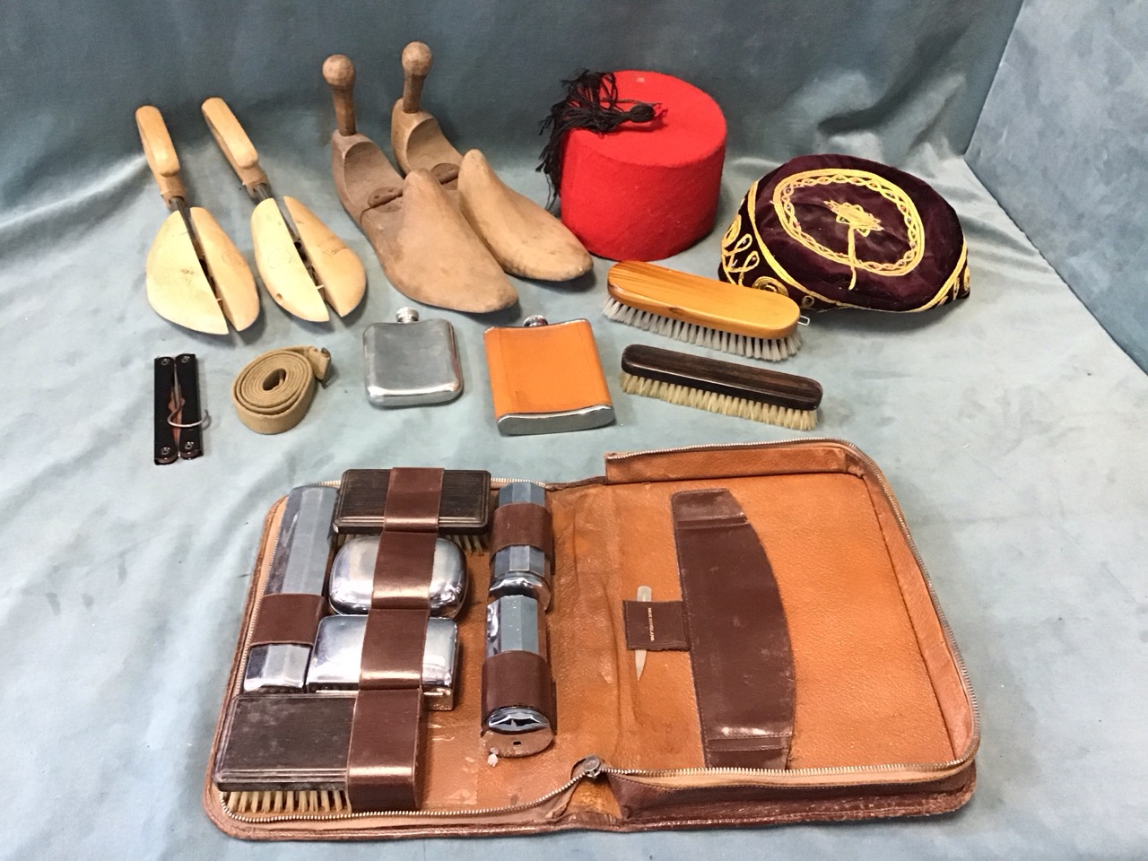 Gentlemans accessories - a leather toilet case with containers & pair of rosewood hairbrushes,