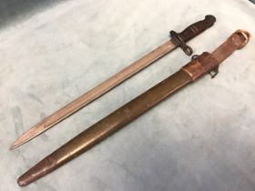 An American WWI bayonet with wood hilt & leather scabbard, stamped US & dated 1917. (22.5in)