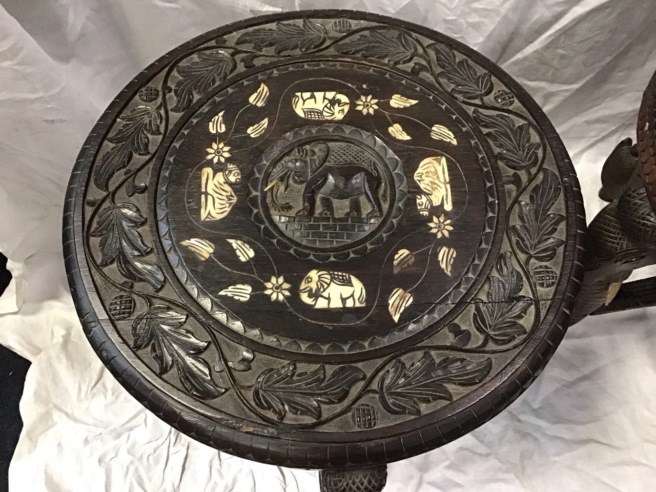 A pair of Indian carved hardwood occasional tables with circular tops inlaid with elephants, - Image 3 of 3