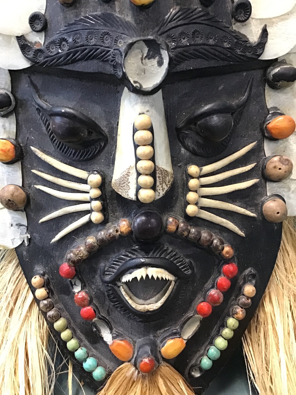 An Amazonian Indian hardwood wall mask decorated with coloured beads and seeds, scales, piranha - Image 2 of 3