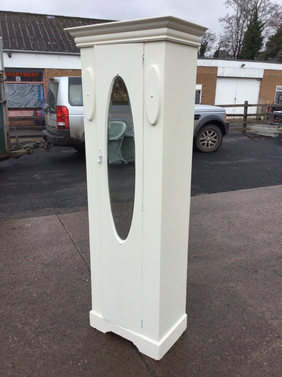 An Edwardian painted wardrobe with moulded cornice above a door with oval bevelled mirror opening to - Image 3 of 3