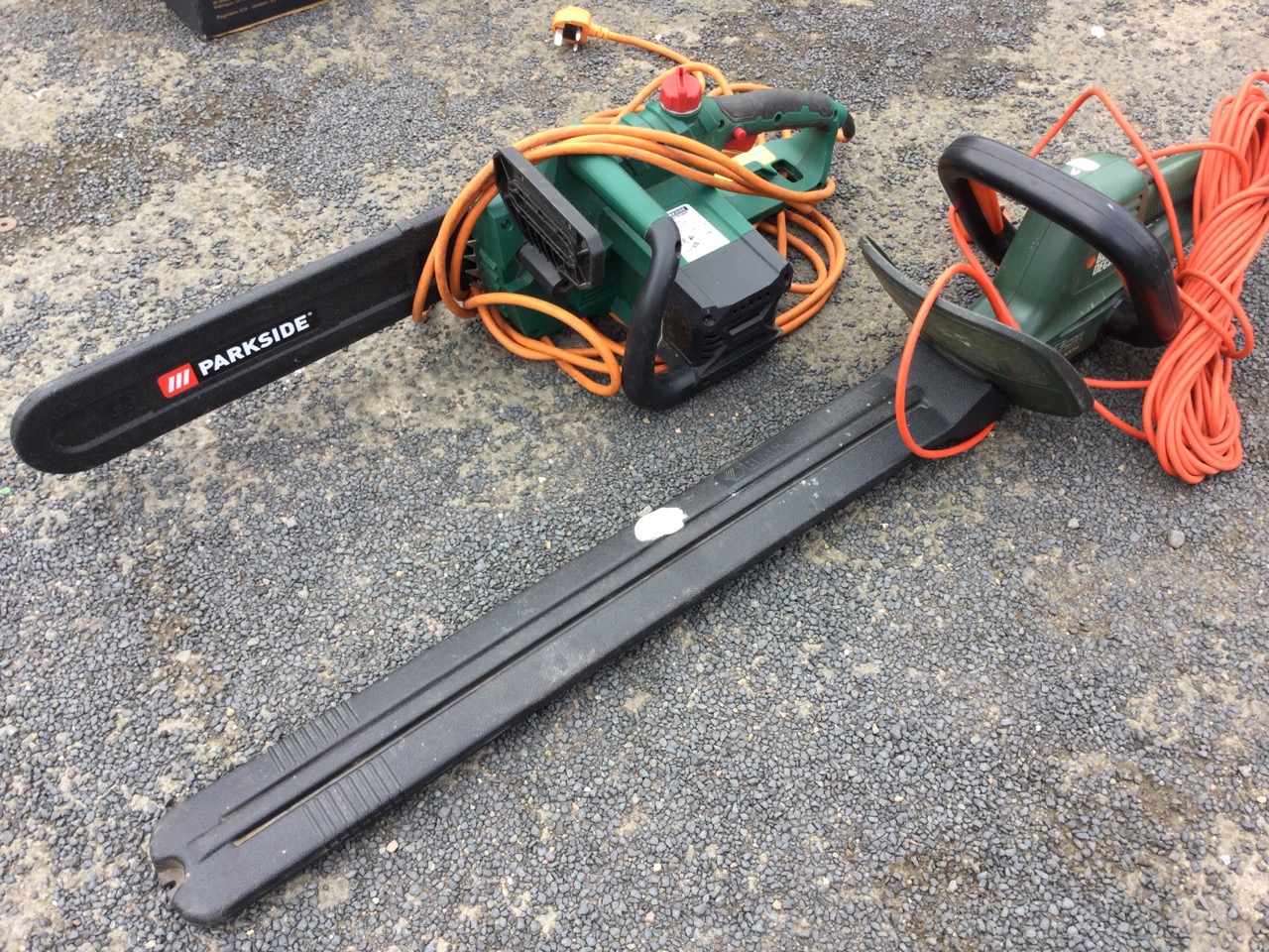 A Black & Decker 500w electric hedgecutter with long cable; and a Parkside electric chainsaw. (2)