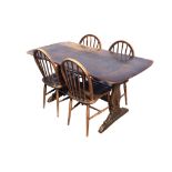 An Ercol elm dining table with rounded rectangular top on shaped trestle supports joined by a