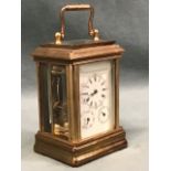 A miniature gilt brass corniche cased carriage clock with bevelled glass panels and enamelled dial