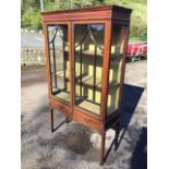 An Edwardian satinwood banded mahogany display cabinet with moulded cornice above a pair of astragal