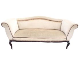 An Edwardian upholstered sofa with arched rolled back and rectangular sprung seat flanked by