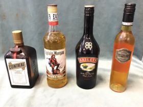 Three 70cl bottles - Cointreau, Captain Morgan Spiced Gold rum, Baileys Original Irish Cream, and