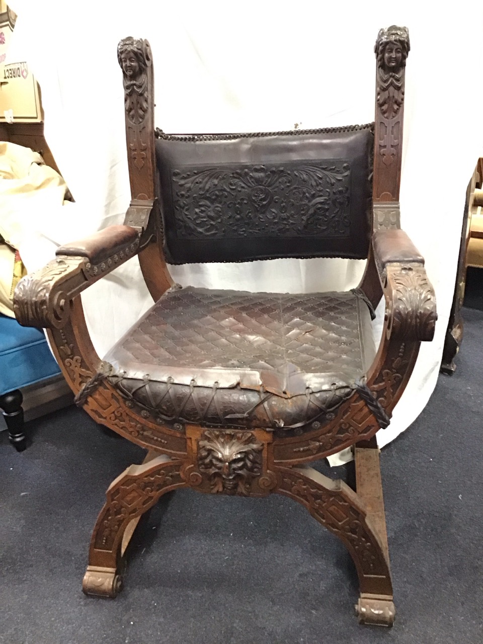 A C19th Renaissance style oak armchair with foliate stamped leather upholstered backrest on scrolled - Image 2 of 3