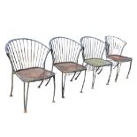 A set of four garden chairs with rounded backs on spindles above mesh seats, the legs on pad