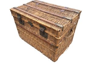 An Edwardian cane hamper or laundry basket with wood slats and brass mounts - the interior lined. (