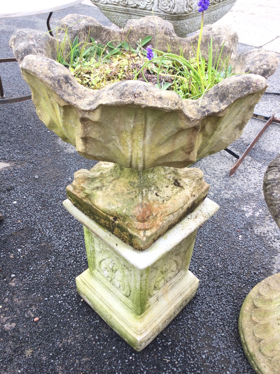 A composition stone garden urn on stand, with scalloped leaf moulded pot on square base with - Image 2 of 3