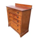 An Edwardian mahogany chest of five long graduated drawers mounted with brass ring rosette