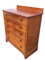 An Edwardian mahogany chest of five long graduated drawers mounted with brass ring rosette