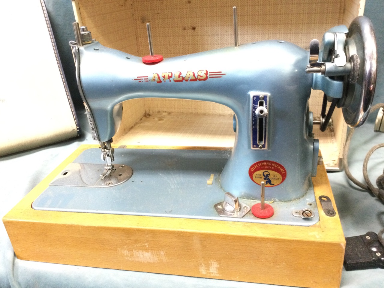A 50s cased Atlas electric portable sewing machine, with bakelite foot pedal on a beech base, the - Image 3 of 3