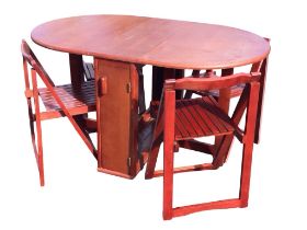 An oak veneered folding dining table and chair set with two leaves supported on gatelegs flanking