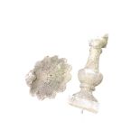 A composition stone birdbath with shell cast scalloped bowl on baluster column above square plinth -