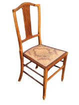 An Edwardian mahogany bedroom chair with chequer strung arched back and pierced spindle splat