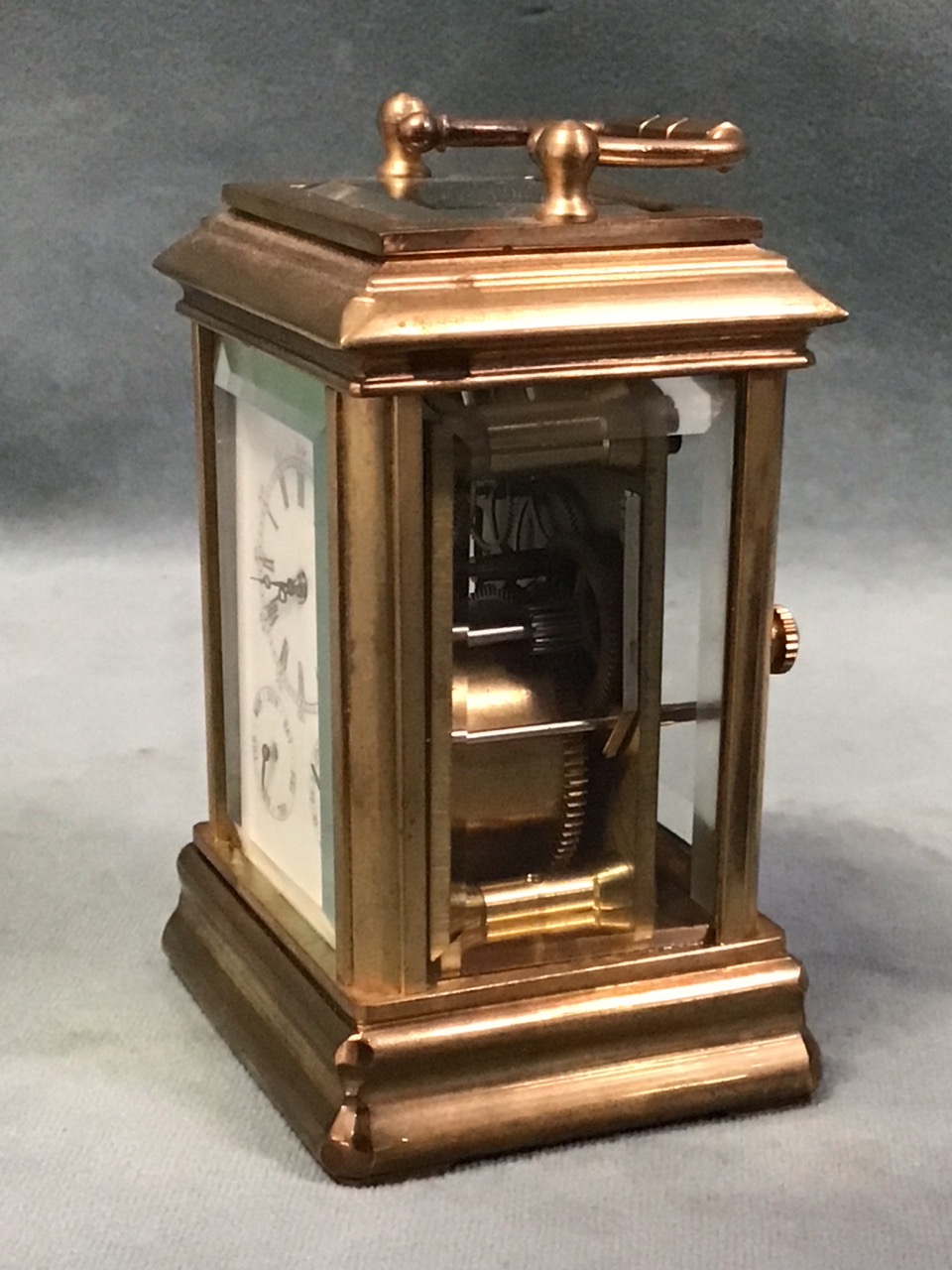 A miniature gilt brass corniche cased carriage clock with bevelled glass panels and enamelled dial - Image 3 of 3