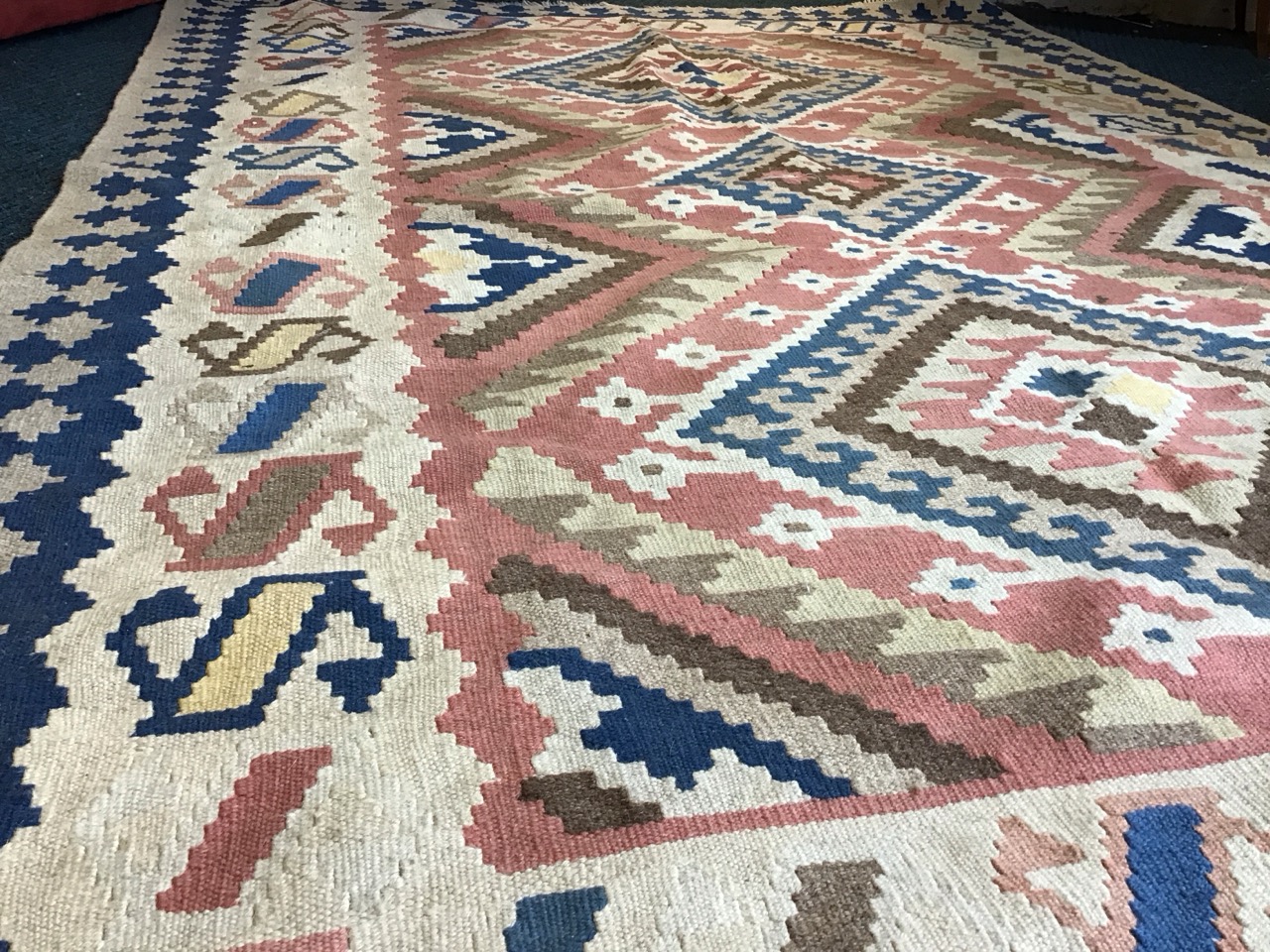 An Anatolian wool kilim carpet with three hooked lozenge medallions on a pink field within repeating - Image 3 of 3