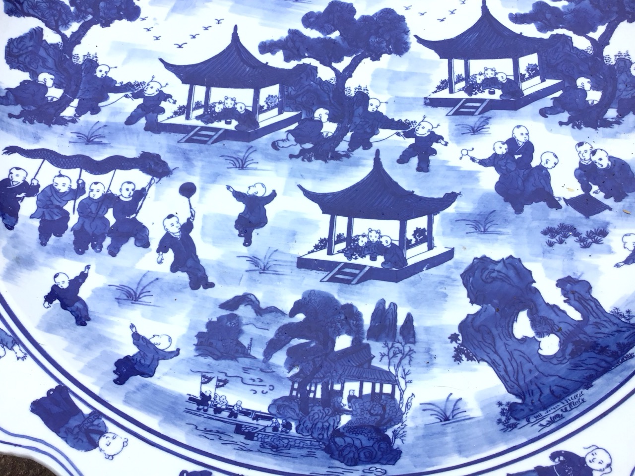 A large Chinese blue and white circular scalloped charger decorated with children in a garden amid - Image 3 of 3